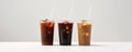 Three cups of iced coffee mockup with colorful straws on a white background. Royalty Free Stock Photo