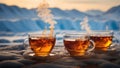 Three cups of tea on the background of the mountains and the sunset