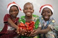 Three Cute African Children celebrate Christmas Royalty Free Stock Photo
