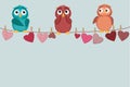 Three cute colored owlet sitting on a string. A red hearts
