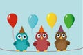 Three cute colored owls sitting on a rope and holding balloons.