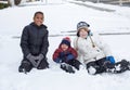 Three cute diverse boys playing together in the snow outdoors