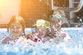 Three cute girls playing in swimming pool Royalty Free Stock Photo