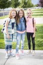 Three cute school girls heading off to school Royalty Free Stock Photo
