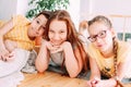 Three cute smiling children friends tweens lying on the floor