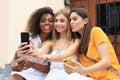 Three cute young girls friends having fun together, taking a selfie at the city Royalty Free Stock Photo