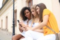 Three cute young girls friends having fun together, taking a selfie at the city Royalty Free Stock Photo
