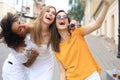 Three cute young girls friends having fun together, taking a selfie at the city Royalty Free Stock Photo