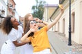 Three cute young girls friends having fun together, taking a selfie at the city Royalty Free Stock Photo