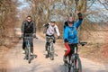 Three cyclists outside the city, spring bike ride