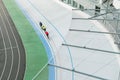 Three cyclists train on the velodrome, top view. Professional cyclists ride on the bike path, top view. Cycling. Track bike.