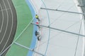 Three cyclists train on the velodrome, top view. Professional cyclists ride on the bike path, top view. Cycling. Track bike.