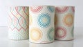 Three cylindrical ceramic containers with dot patterns in red, blue, and yellow are aligned in a row. Royalty Free Stock Photo