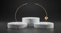 Three cylindrical marble pedestals of varying heights are arranged against a dark