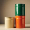Three cylindrical metal containers are arranged on a flat surface. One is cream- Royalty Free Stock Photo