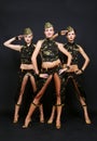 Three dancers in military uniform
