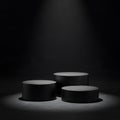 Three dark gray cylindrical display podiums on textured dark floor stage platform Royalty Free Stock Photo