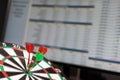 Three Darts hit the target against the background of exchange statistics on the monitor screen