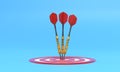 Three darts hitting a red target on the center on blue background with copy space Royalty Free Stock Photo