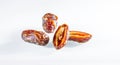 Three dates with shadows on a white background close-up