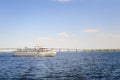 A three-deck motor ship floats along the river