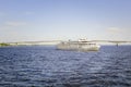 A three-deck motor ship floats along the river