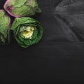 Three decorative cabbages, fresh vegetables. Background of dark wooden texture Royalty Free Stock Photo