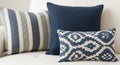 Cozy Arrangement of Three Decorative Throw Pillows with Blue and White Patterns on a White Sofa cushions Royalty Free Stock Photo