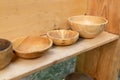 Three deep deep plates stands on a shelf of a summer kitchen natural dishes