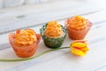 Three delicious cupcakes with orange cream