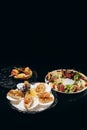 Three delicious dishes on a black background