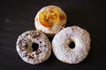 Three delicious Donuts on a black background Royalty Free Stock Photo