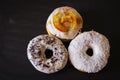 Three delicious Donuts on a black background Royalty Free Stock Photo