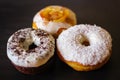 Three delicious Donuts on a black background Royalty Free Stock Photo