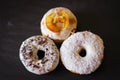 Three delicious Donuts on a black background Royalty Free Stock Photo