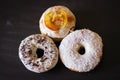 Three delicious Donuts on a black background Royalty Free Stock Photo