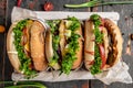 Three delicious homemade burgers of beef, cheese and vegetables, diet temptation resulting in unhealthy nutrition. top view Royalty Free Stock Photo