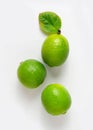 Three delicious limes with a leaf on a white background. Royalty Free Stock Photo
