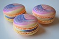 Three delicious macarons with a colorful galaxy pattern and glitter sparkling on a white background Royalty Free Stock Photo