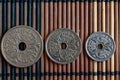 Three Denmark coins denomination is 5, 2 and 1 krone (crown) - back side lie on wooden bamboo table, good for background or postca