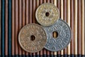 Three Denmark coins denomination is 5, two and 1 krone (crown) lie on wooden bamboo table, good for background or postcard