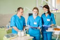 Three dentists looking at the folder at the stomatology clinic