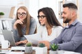 Three designers working together on laptop in office Royalty Free Stock Photo