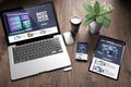 three devices on wooden desk top view best web design Royalty Free Stock Photo