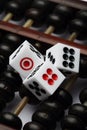 Three dice on abacus are symbolic of gambling Royalty Free Stock Photo