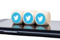 Three dice with blue Twitter bird logo icons on a modern smartphone screen. Social media engagement concept, addiction. Tweeting Royalty Free Stock Photo