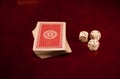 Three dice cubes and deck of cards on dark reflecting wooden background games casino fortune Royalty Free Stock Photo