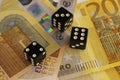 Three dice on 200 euro banknotes, close up. Royalty Free Stock Photo