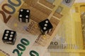Three dice on 200 euro banknotes, close up. Royalty Free Stock Photo