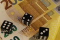 Three dice on new 200 euro banknotes, close up. Royalty Free Stock Photo
